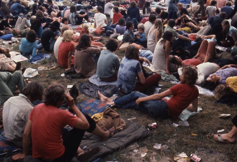 Bezoekers tijdens het Holland Pop Festival in 1970 zitten in het gras