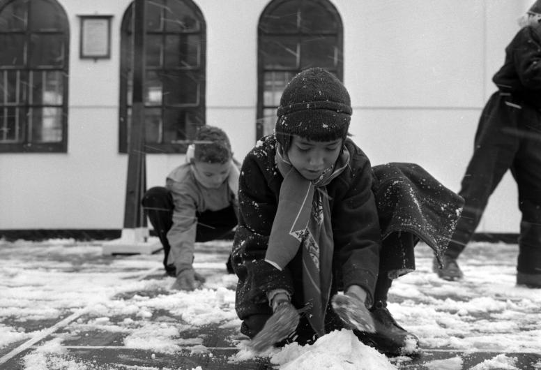 Gerepatrieerde kinderen uit Indonesie maken kennis met sneeuw na aankomst van de Sibajak aan de Lloydkade, 19-01-1958.